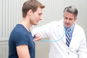 doctor listening to patient's heart