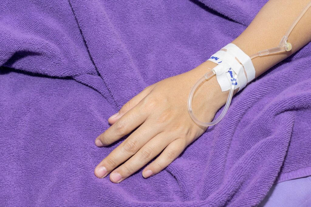 hand getting IV fluid injection