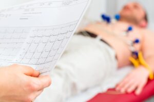 doctor looking at patient's EKG paper
