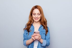 Woman checking wait times on mobile phone