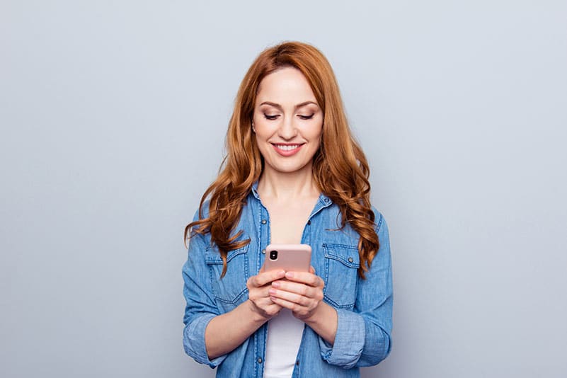 Woman checking wait times on mobile phone