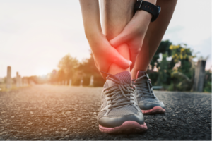 A person holding their ankle in pain