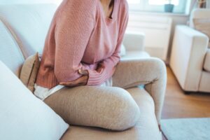 Woman with cramps holding her stomach in pain